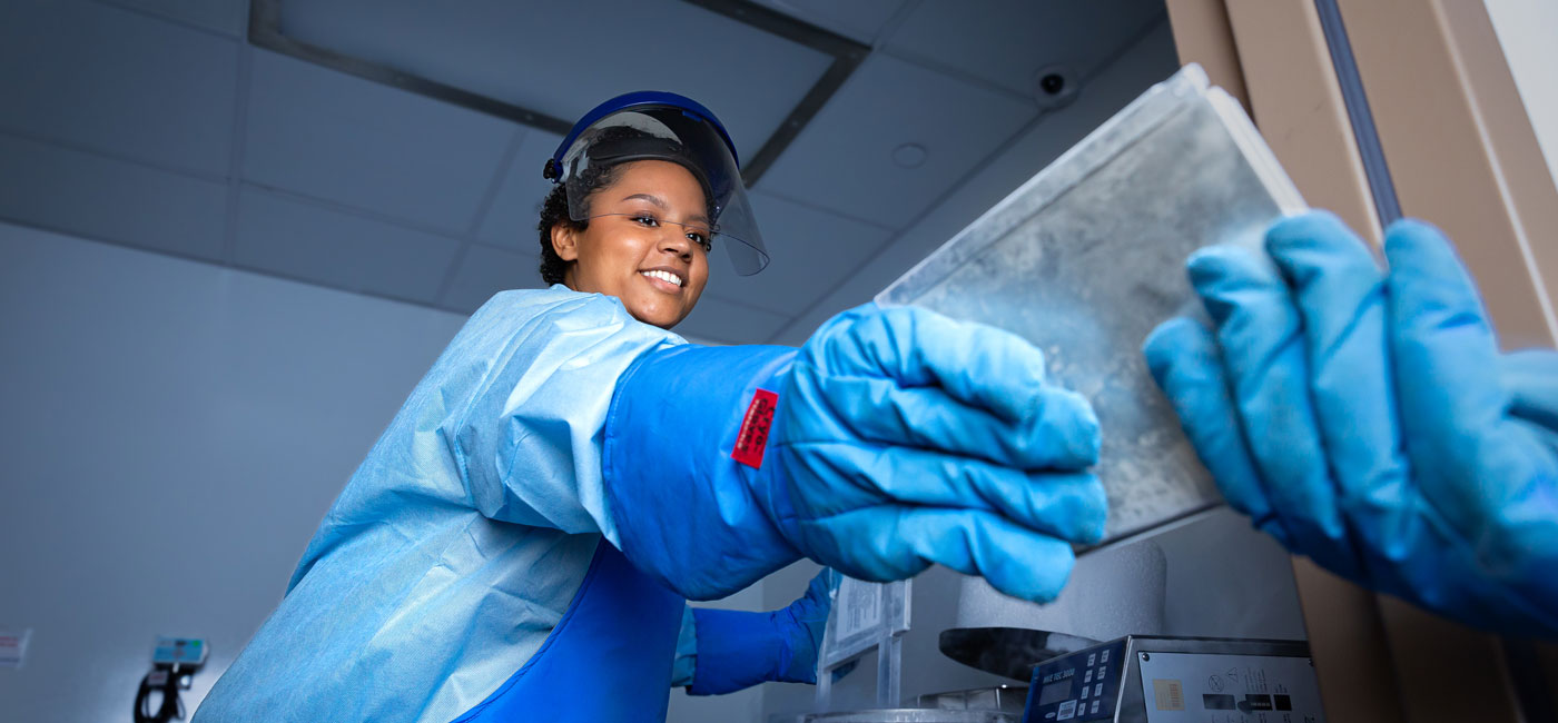 Jasmine Cherry, a cell therapy technologist, holds a block of frozen tumor-infiltrating lymphocytes that are being transformed into a personalized treatment. 