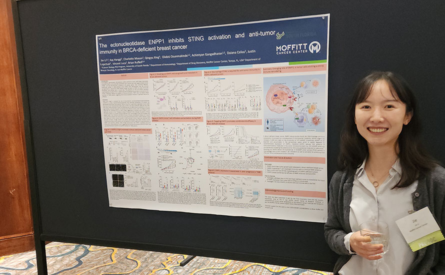 Jie Li in front of her poster presentation