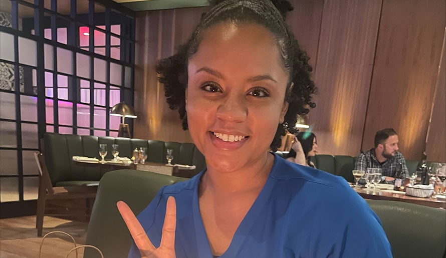 Jasmine Cherry holds up two fingers to mark her two-year anniversary
