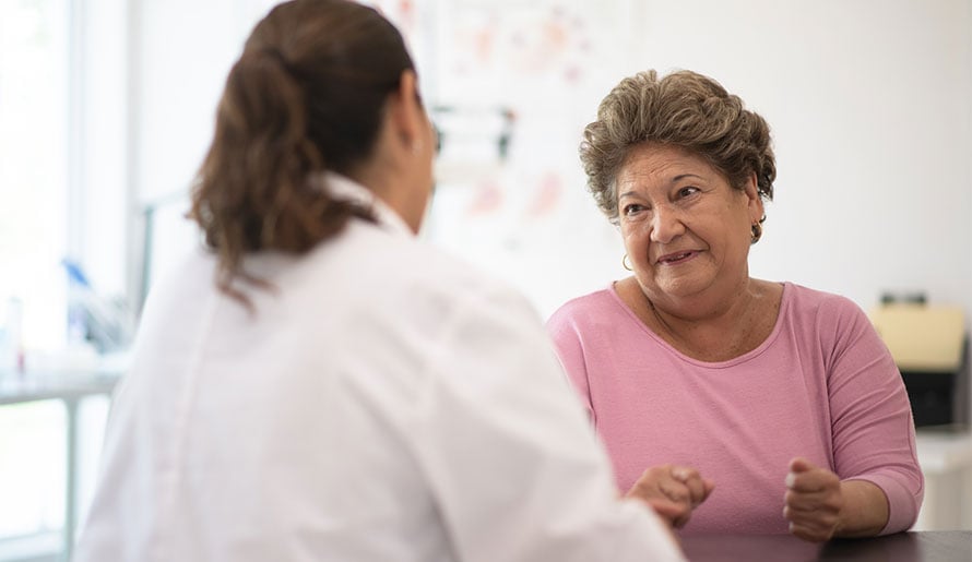 Female ovarian cancer patient speaking with doctor