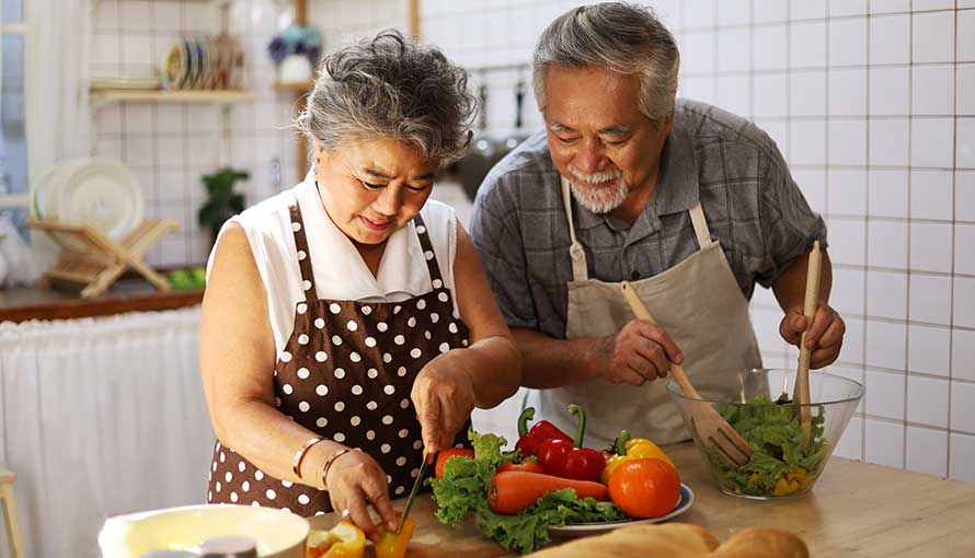 Couple cooking with healthy vegetables
