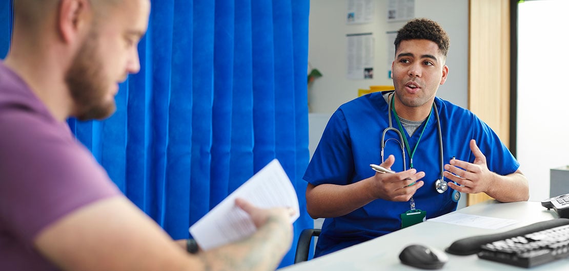 male patient with osteosarcoma talks to nurse