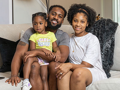 Jarryd Reid poses with his wife, Aramis, and daughter, Jaxin.