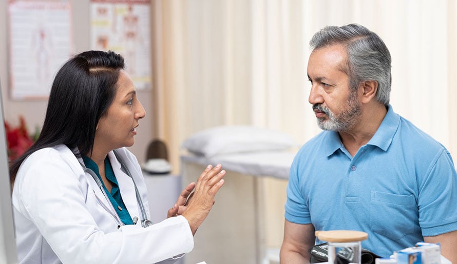 Doctor explaining difference between hemorrhoids and colon cancer