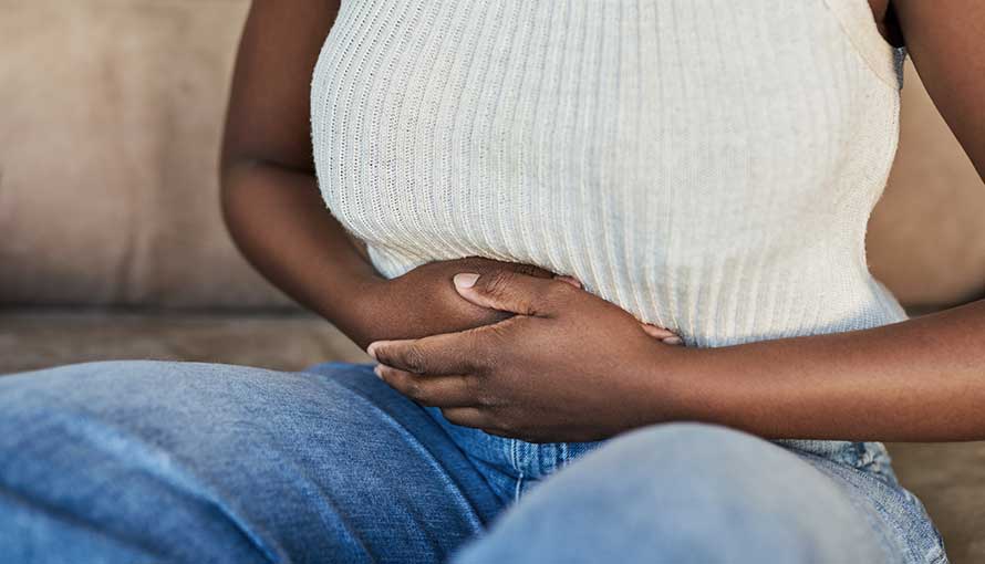 a woman suffering from stomach pain