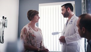 A doctor talks to a woman in a clinic