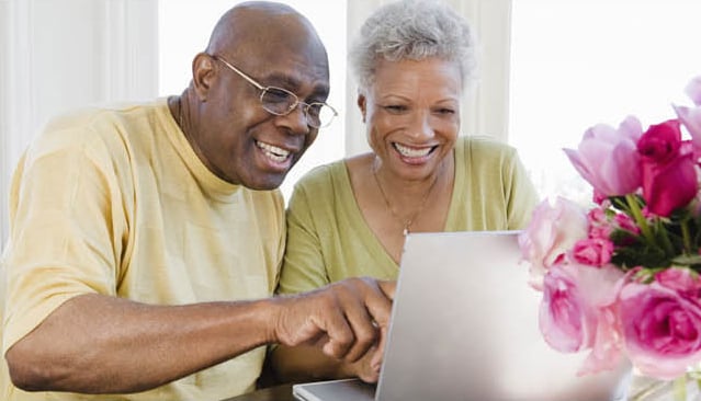 a couple review their estate gift on a computer