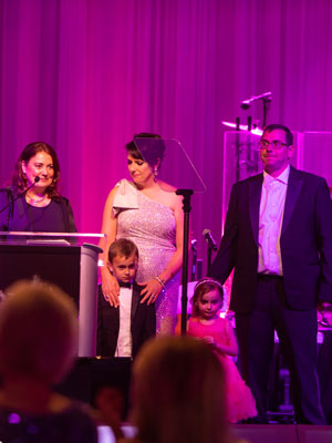 Jamie Losito and family take the stage at the Magnolia Ball to thank donors for their generous support.