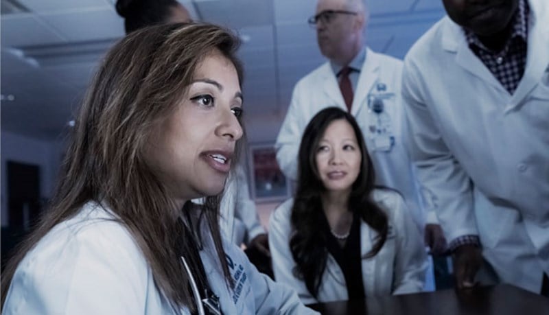 doctors review patient's chart