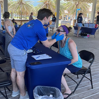 A woman gets screened for head and neck cancers at Pier 60 in 2023.