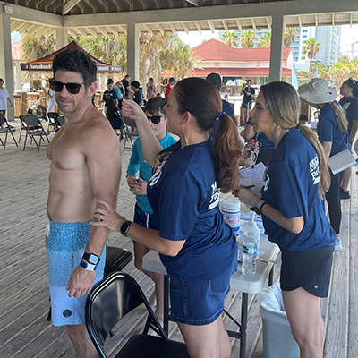 Skin cancer screeners examine a beachgoer in 2023.