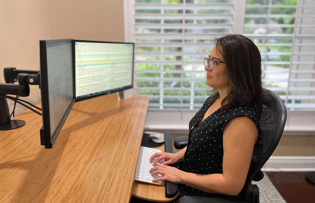 Photo of Sandra Cadavid working on her computer at home
