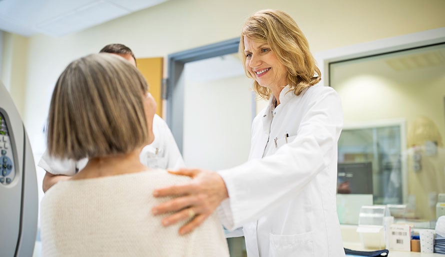 Physician speaking to patient before a CT scan