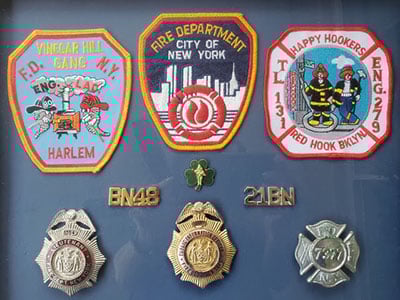 Sanford displays badges from his firefighter career.