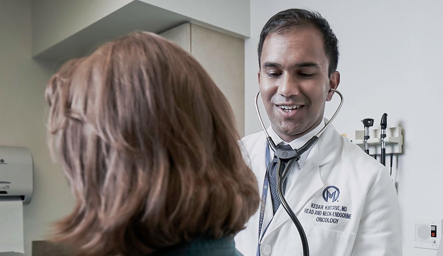 Dr. Kedar Kirtane with Head and Neck Oncology Program examines patient