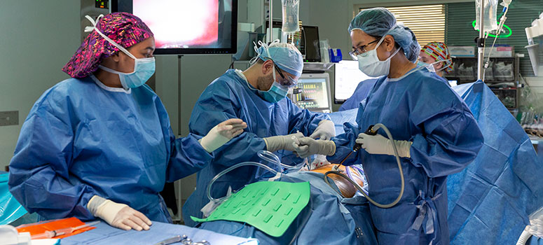 Thoracic surgeon Joelle Baldonado, MD, leads a surgical team during a procedure to remove a portion of a patient’s tumor and collect T cells to begin the TIL process.