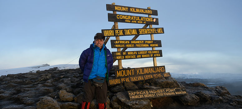 Morris reaches the highest point on Mount Kilimanjaro.