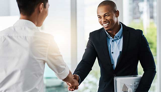 A man shakes hands with a job candidate