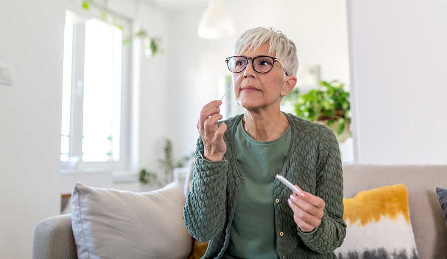 Middle age female using covid test at home