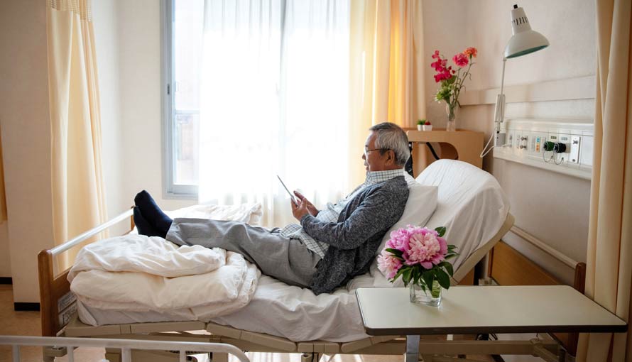 man using tablet to communicate with family