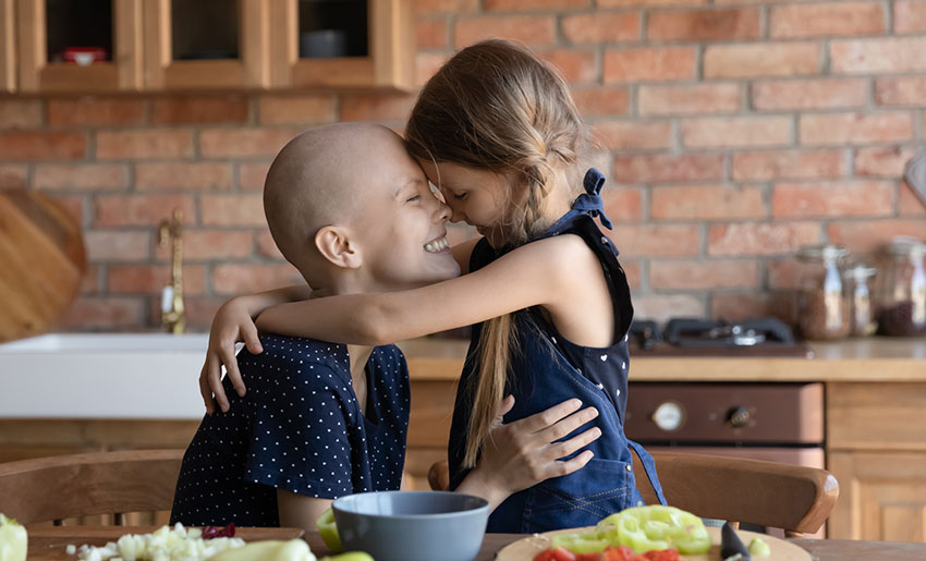 Mother and daughter hugging in kitchen