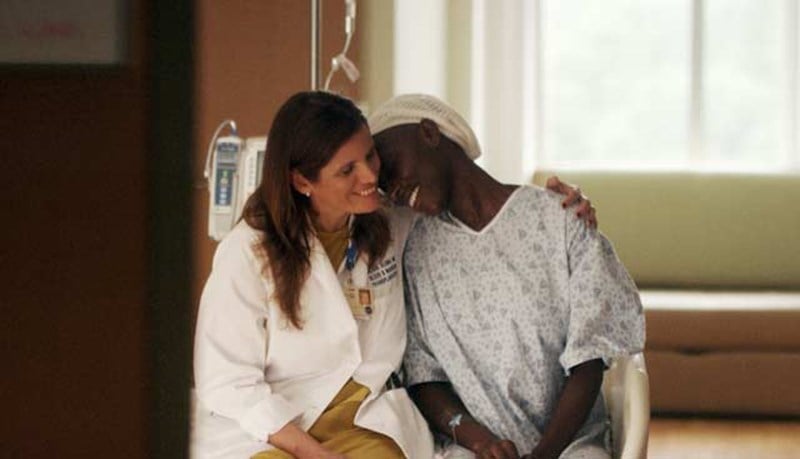 A doctor giving a bone marrow transplant patient a hug