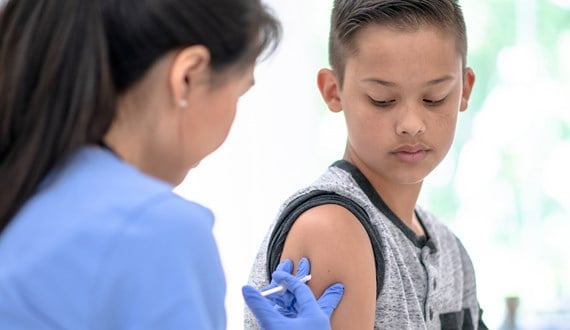 A boy receiving a HPV vaccine