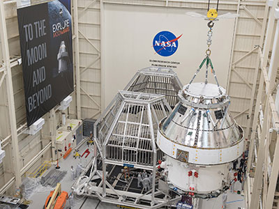 NASA’s Orion spacecraft–the crew module and European-built service module—is being lifted into a thermal cage and readied for its move on Tuesday into the vacuum chamber at NASA’s Plum Brook Station for testing in two phases. Courtesy: NASA