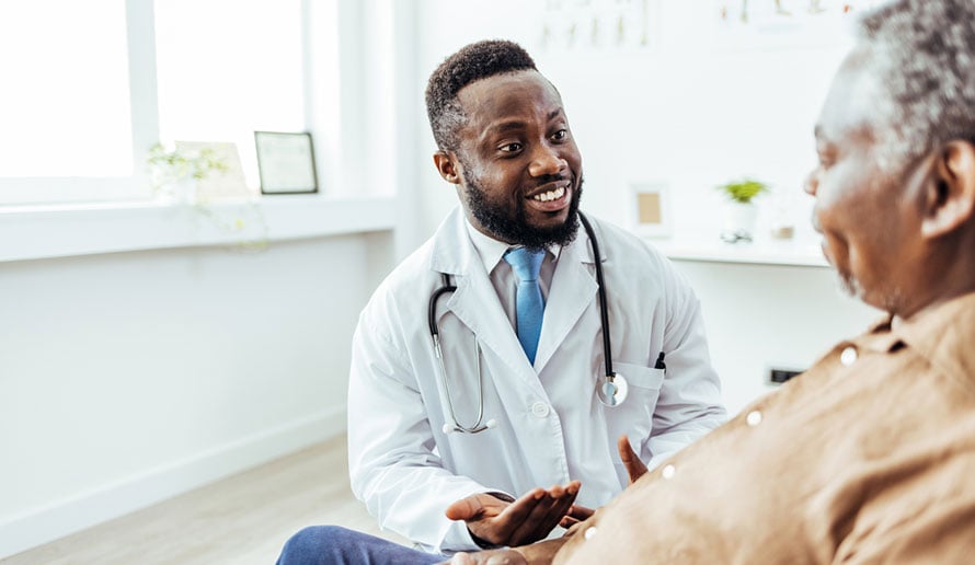 doctor speaks with patient about adrenal cancer causes