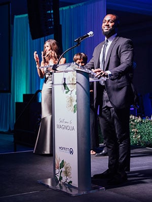 Jarryd Reid takes the stage at this year's ball to thank Moffitt for saving his life.