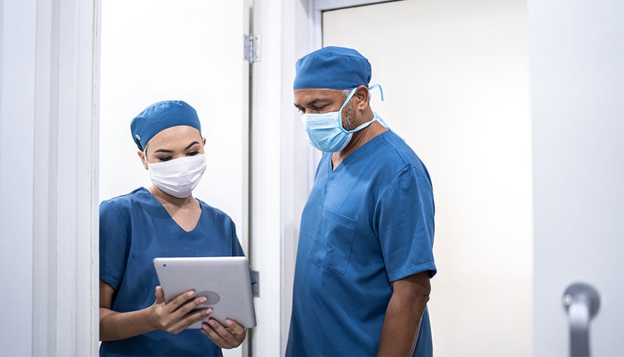 Surgeon looking at tablet prior to low anterior resection