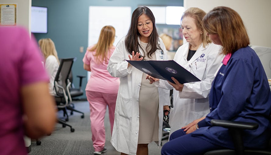 Moffitt doctors review a patient's screening mammography files