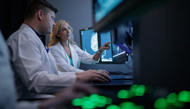 Doctor's reviewing mammograms