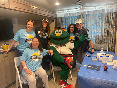 The Mole Patrol team takes a break from performing screening exams to pose with Wally the Green Monster. 