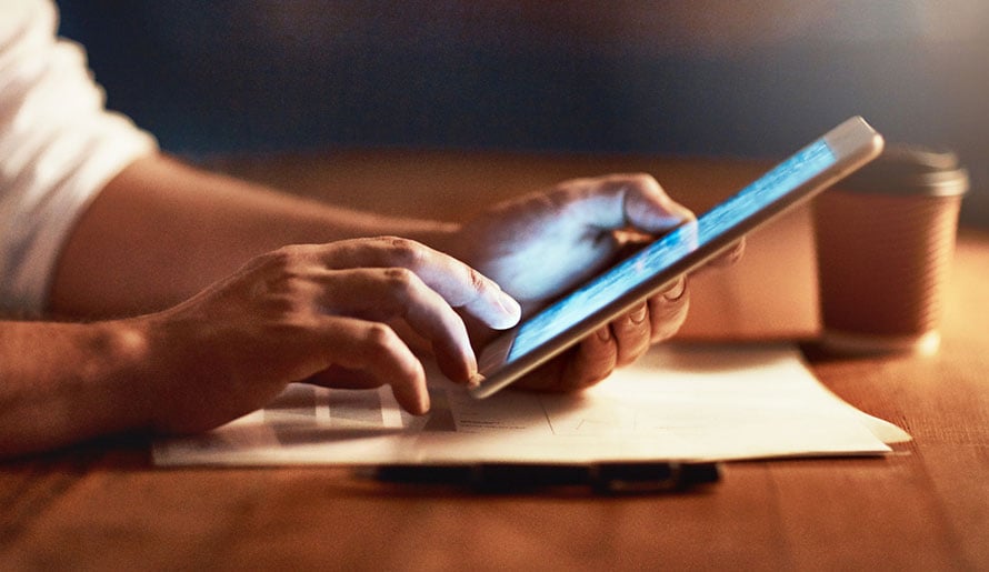 Man scrolling through iPad