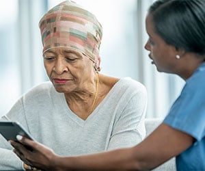 Patient looking at tablet with cancer results