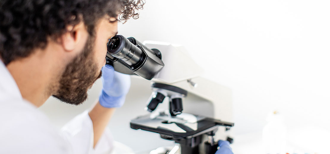 Pathologist looking in microscope