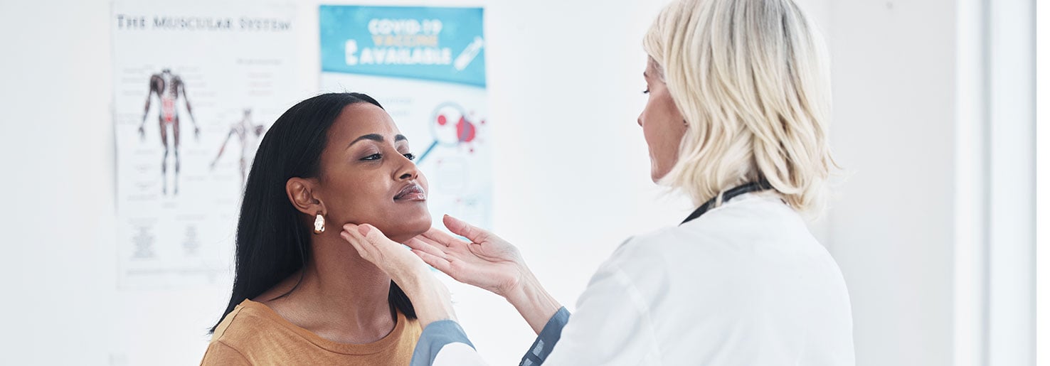 Doctor checking patient for papillary thyroid carcinoma signs