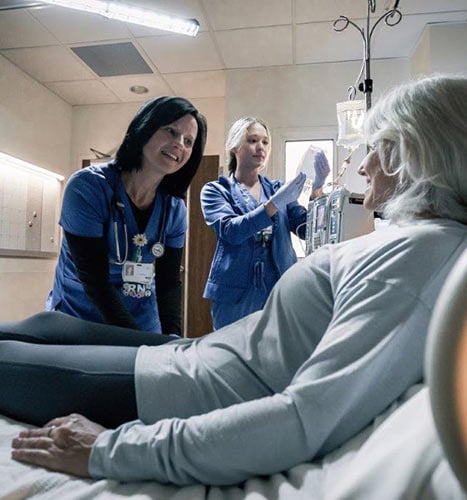 Nurses with a patient receiving cell therapy