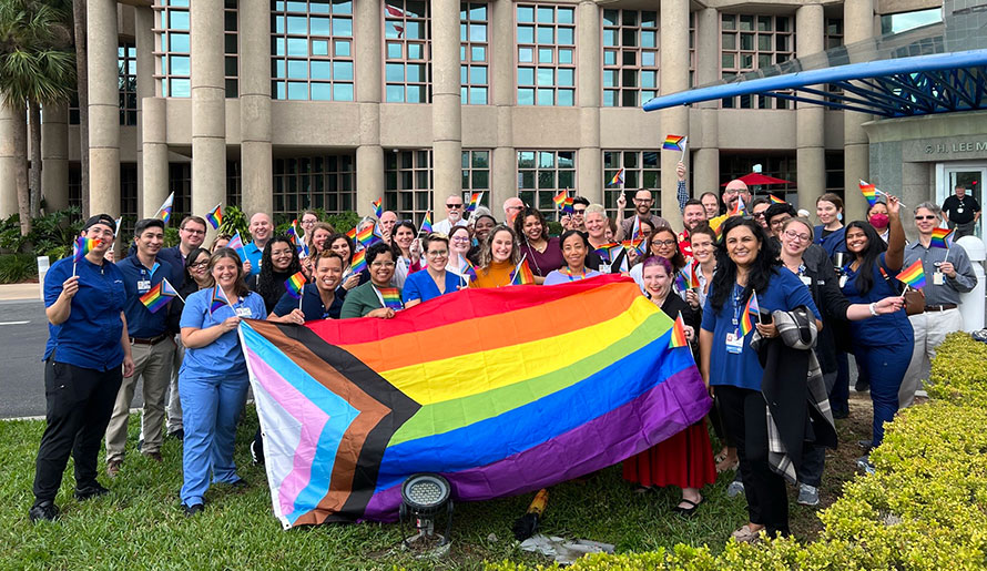 Moffitt Unity holding pride flag