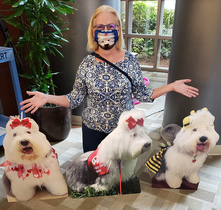 Karen Burdash, Moffitt Volunteer, shows off the cardboard cutouts of her dog, Gracie.