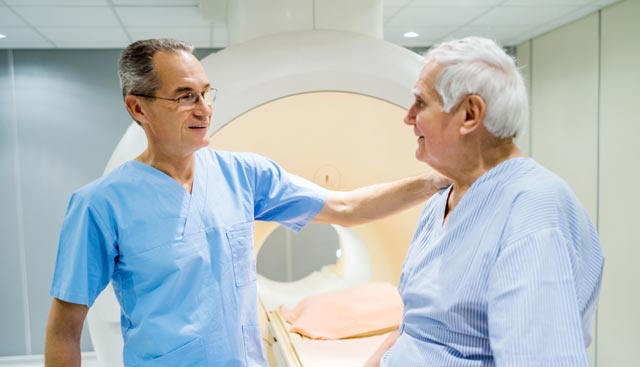 A radiation oncologist with a patient