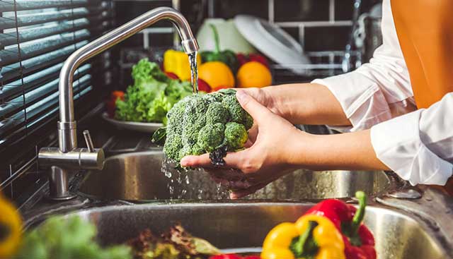 Washing vegetables to prepare a healthy meal