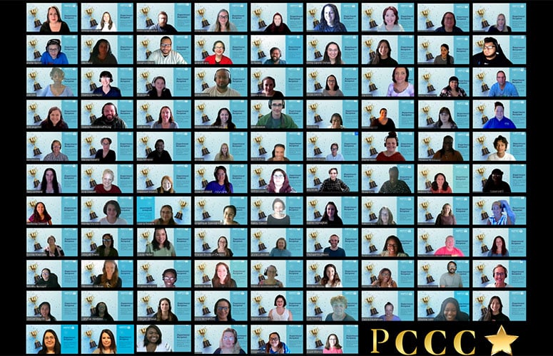 Nearly a hundred people appear on a Zoom grid. They all have the same background showing a trophy in honor of their award.