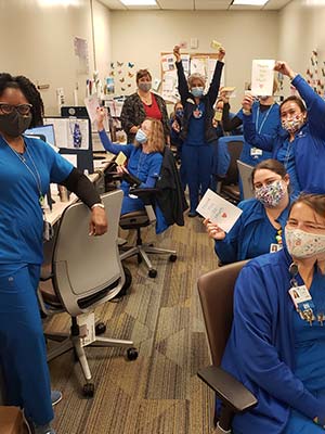 photo of nurses holding cards