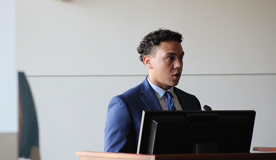 MAP fellow speaks at podium