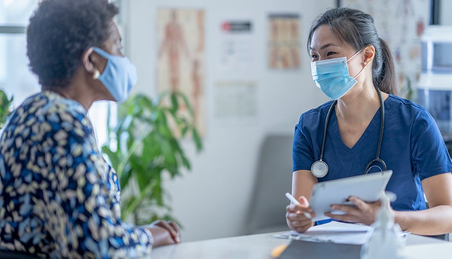 A doctor talking to a patient about cervical cancer treatments