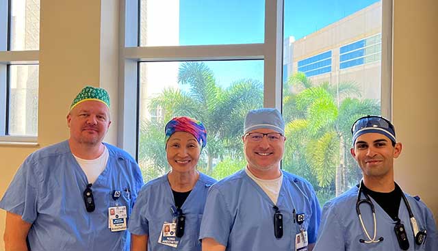 Four healthcare providers in scrubs 