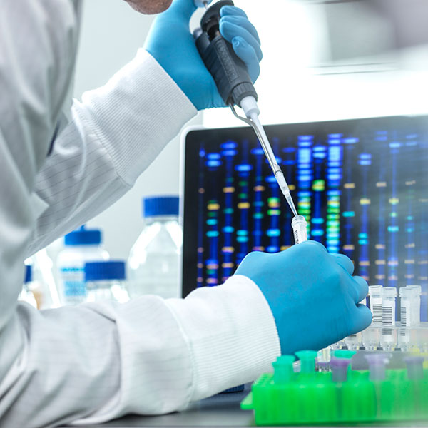 Scientist pipetting sample into a vial for DNA testing