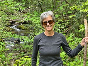 Pam hiking in a woods